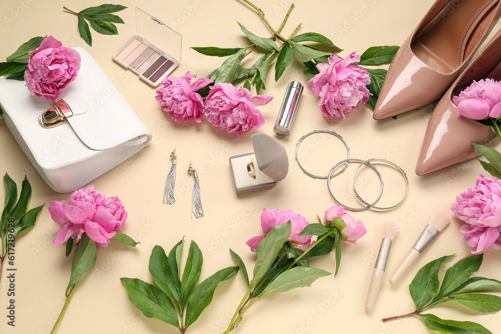 Composition with beautiful engagement ring, stylish accessories, cosmetics and peony flowers on color background