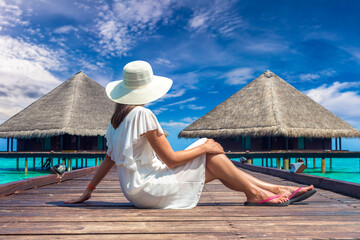 Sticker - Woman sitting on the wooden pier