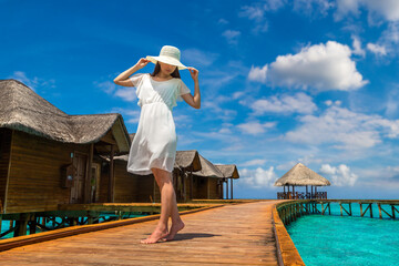 Poster - Woman standing on the wooden pier