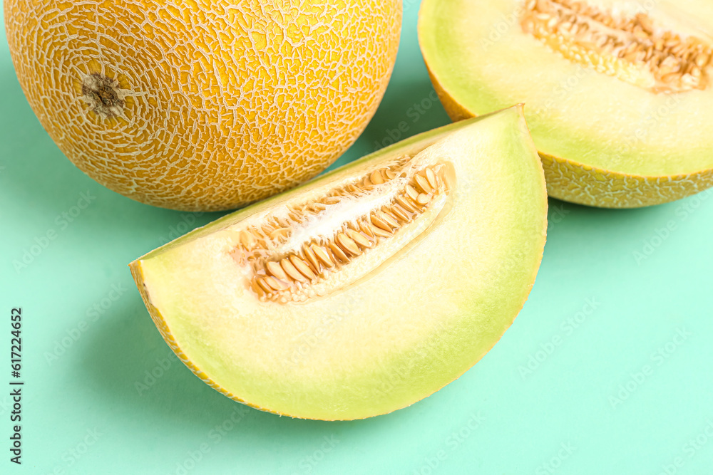 Sweet melon with pieces on turquoise background