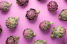 Top View Of Artichoke Vegetables On Pastel Violet Background