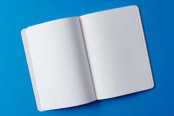 Canvas Print - Close up of open book with copy space on blue background