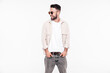 © halayalex - Portrait of handsome smiling stylish hipster lambersexual model. Sexy man dressed in white T-shirt and jeans. Fashion male isolated on white background in studio. In sunglasses