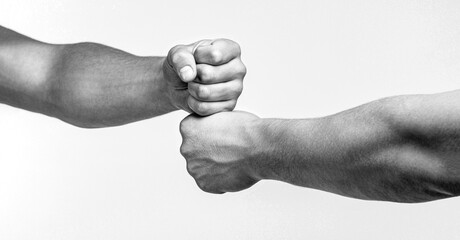 Friendly handshake, friends greeting. Hands of man people fist bump team teamwork, success. Man giving fist bump. Black and white