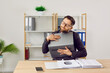 Young office worker, business man or financial accountant loves his laptop computer very much. Funny man with closed eyes sitting at working desk with paperwork and tenderly hugging modern notebook PC