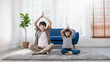 Portrait of young asian father daughter prepare for relax post in yoga meditation. Das little girl toddler yoga exercise on sofa at home. Together lifestyle, Father's Day, lovely family single dad.
