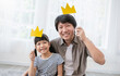 © paulaphoto - Portrait of asian father and child daughter playing having fun together. Beautiful funny girl daddy have crowns on sticks. Fun love family day lifestyle single dad love father’s day holiday concept