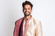 Portrait of a young handsome Indian man in a pink suit.