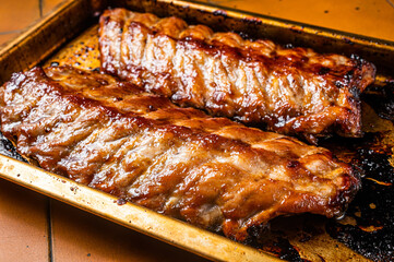 Barbecue grilled pork spare ribs. Orange background. Top view