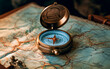 Close-up of a old style compass resting on a map