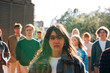 © Carlo Prearo - close up portrait of a young woman on picket protest with a large group of her peers