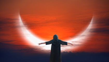 Wall Mural - Young girl wearing abaya with arms up happy crescent moon in the background