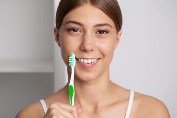 Wall Mural - Happy Lady Brushing Teeth With Toothbrush Standing In Bathroom