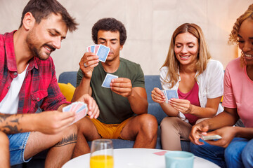 Friends having fun playing card games at home