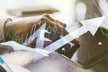 Wall Mural - Multi exposure of abstract financial diagram with upward arrow and hand working with a digital tablet on background, rise and breakthrough concept