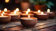 Lit Candles In Small Decorative Clay Pots And Tea Light Candle Burning On Round Wooden Board. Celebration, Religion, Tradition And Ceremony Concept