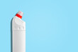 Plastic white bottle for cleaning products and household chemicals on a blue background. Copy space. House cleaning.
