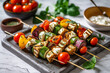 skewer platter with grilled vegetables kebabs, veggies and salad