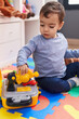 © Krakenimages.com - Adorable hispanic boy playing with tools toy sitting on floor at kindergarten