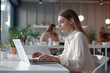 © Ployker - Young woman in white whear using laptop computer with white mockup screen at office. Freelance, student lifestyle, education, technology and online shopping concept