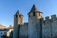The Château Comtal, Count’s Castle, Is A Medieval Castle In The Cité Of Carcassonne, Tall Towers And Wall, And A Bridge To A Fortified Gate.
