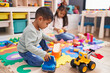 © Krakenimages.com - Adorable boy and girl playing with construction blocks and car toy at kindergarten