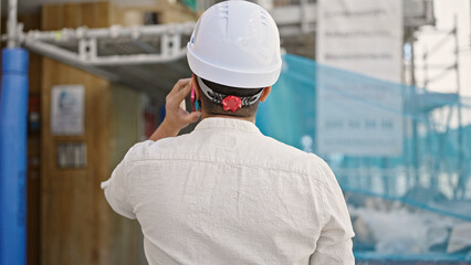 Sticker - Young hispanic man architect talking on smartphone at street