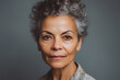 © ADDICTIVE STOCK - Generative AI illustration portrait of mature ethnic female with curly hair looking at camera against gray background