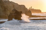 Fototapeta Morze - Ocean wave breaking on rocky shore in Algarve region of Portugal