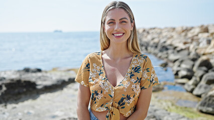 Sticker - Young blonde woman smiling confident standing at seaside