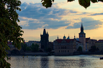 Wall Mural - Picturesque cityscape of medieval buildings along Vltava River in Prague. Scenic sunrise landscape view. Travel and tourism concept. UNESCO World Heritage Site