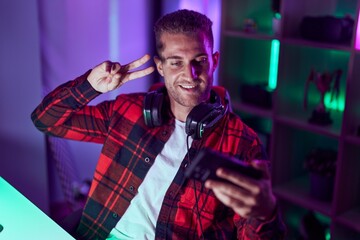 Sticker - Young caucasian man streamer smiling confident make selfie by smartphone at gaming room