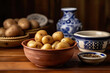 Raw potatoes on a table and in a bowl with a pre