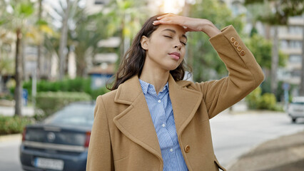 Poster - Young beautiful hispanic woman suffering for headache at park