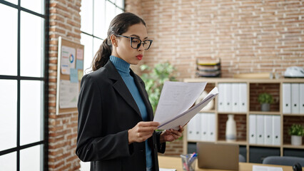 Sticker - Young beautiful hispanic woman business worker reading document at office