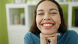 © Krakenimages.com - Young beautiful hispanic woman smiling confident sitting on table at home
