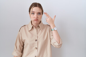 Poster - Young caucasian woman wearing casual shirt shooting and killing oneself pointing hand and fingers to head like gun, suicide gesture.