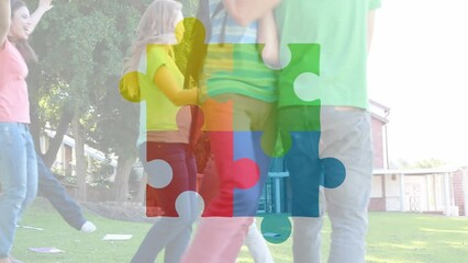 Poster - Animation of connected jigsaw puzzle pieces over happy diverse student jumping in excitement