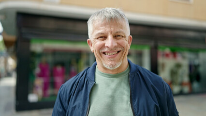 Poster - Middle age grey-haired man smiling confident standing at street