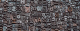Fototapeta Mapy - Letterpress background, close up of many old, random metal letters with copy space