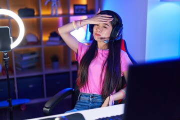 Canvas Print - Young chinese woman streamer stressed using computer at gaming room