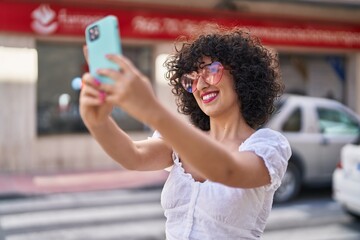 Canvas Print - Young middle east woman smiling confident make selfie by smartphone at street