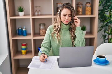 Poster - Young woman call center agent writing on document at home