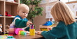 © Krakenimages.com - Adorable boy and girl preschool students sitting on table drawing on paper at kindergarten