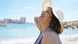 © Krakenimages.com - Young beautiful latin woman tourist smiling confident wearing swimsuit and summer hat at beach