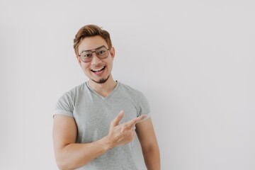 Wall Mural - Happy Asian man with colored hair presenting product. Concept of advertisement.