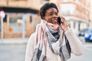 Sticker - African american woman smiling confident talking on the smartphone at street