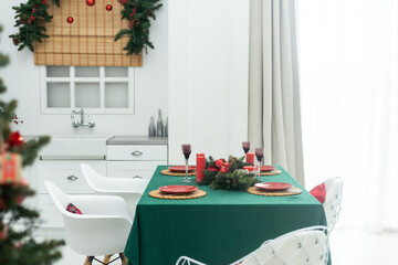 Canvas Print - kitchen decorated with pine garlands and Christmas toys. the table and near is worth Christmas tree. interior bright kitchen decorated for Christmas.