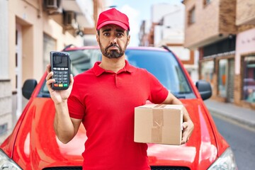 Sticker - Young hispanic man with beard wearing delivery uniform and cap holding dataphone depressed and worry for distress, crying angry and afraid. sad expression.