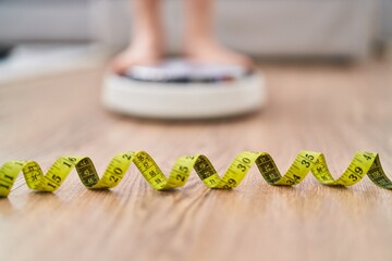 Sticker - Young caucasian woman weighing at home